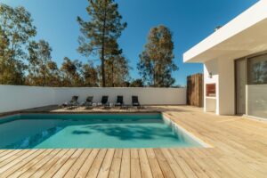 Modernes Pooldesign mit Holzdeck, klarer Pool, elegante Ästhetik – vermittelt direkt den Eindruck eines hochwertigen Komplettsets.